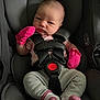 baby, infant, car_seat, graco, pink_mittens, clothing, socks, straps, seat_belt, face, person, child, newborn, cute, indoor, portrait, serious_expression, baby_girl, sitting, safety