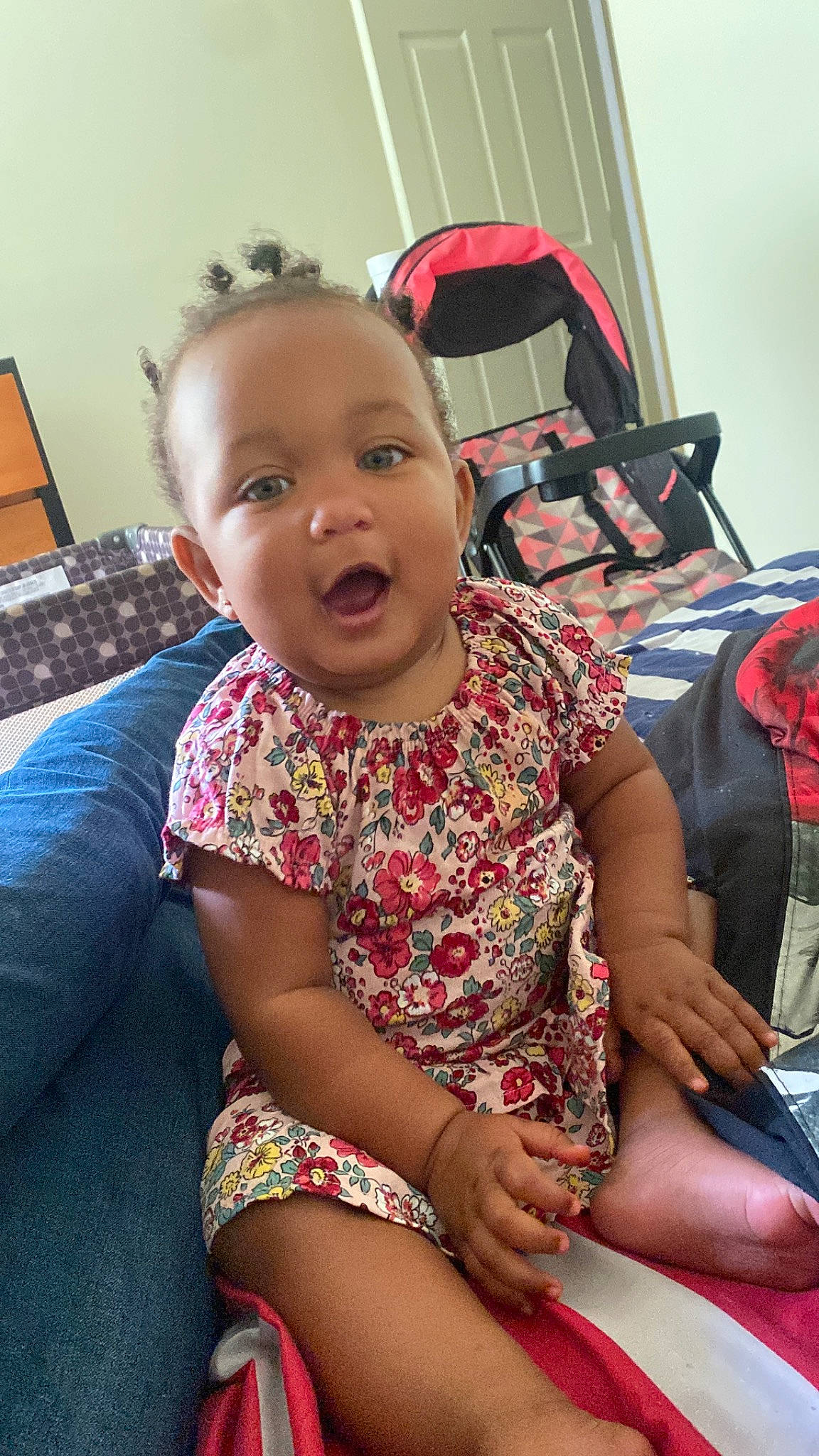 Aniya is registered to the contest to win money with this photo: baby, baby_toddler_clothing, bag, chair, cheek, child, comfort, flooring, fun, happy, human_leg, knee, lap, leisure, luggage_and_bags, pattern, person, room, sitting, thigh