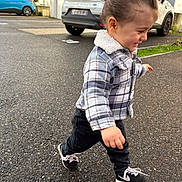 Tylio participe au concours pour gagner de l'argent avec cette photo : asphalt, black_pants, car, casual_clothing, child, curly_hair, daylight, happy, outdoor, plaid_jacket, playful, residential_building, side_view, smiling, sneakers, street, toddler, urban, walking, young_child