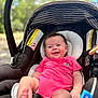 Gracelyn- Claire joined the competition — help win amazing prizes! baby, infant, car_seat, smiling, pink_onesie, outdoor, sunny, happy, child, seat, face, skin, head, person, clothing, daylight, nature, blurred_background, expression, foot