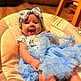 Gracelyn- Claire joined the competition — help win amazing prizes! baby, smiling, headband, blue_dress, baby_seat, indoor, wooden_chair, happy, infant, cute, clothing, person, child, toddler, portrait, face, sitting, fabric, home, warm_lighting