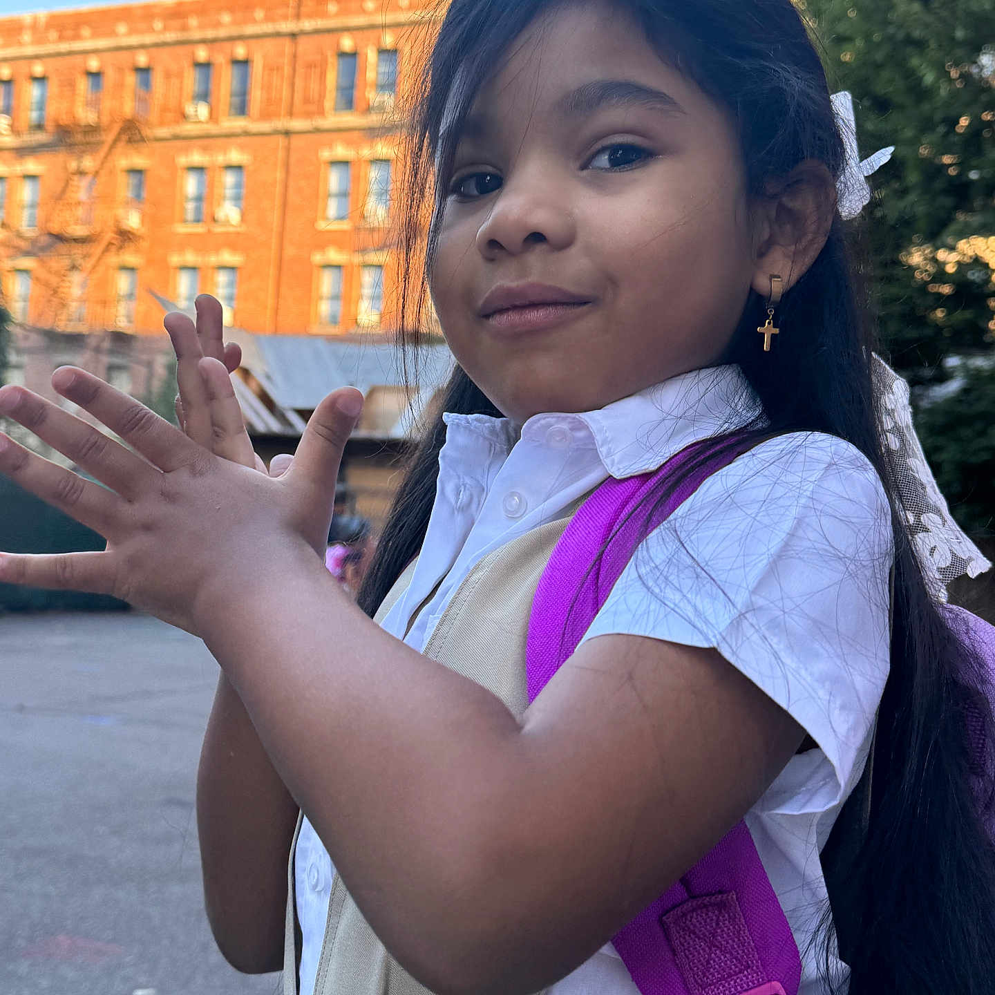 Salice Paris is registered to the contest to win money with this photo: accessories, backpack, bag, blackhair, bodypart, child, face, female, finger, girl, hair, hand, happy, head, nail, person, photography, portrait, smile, urban