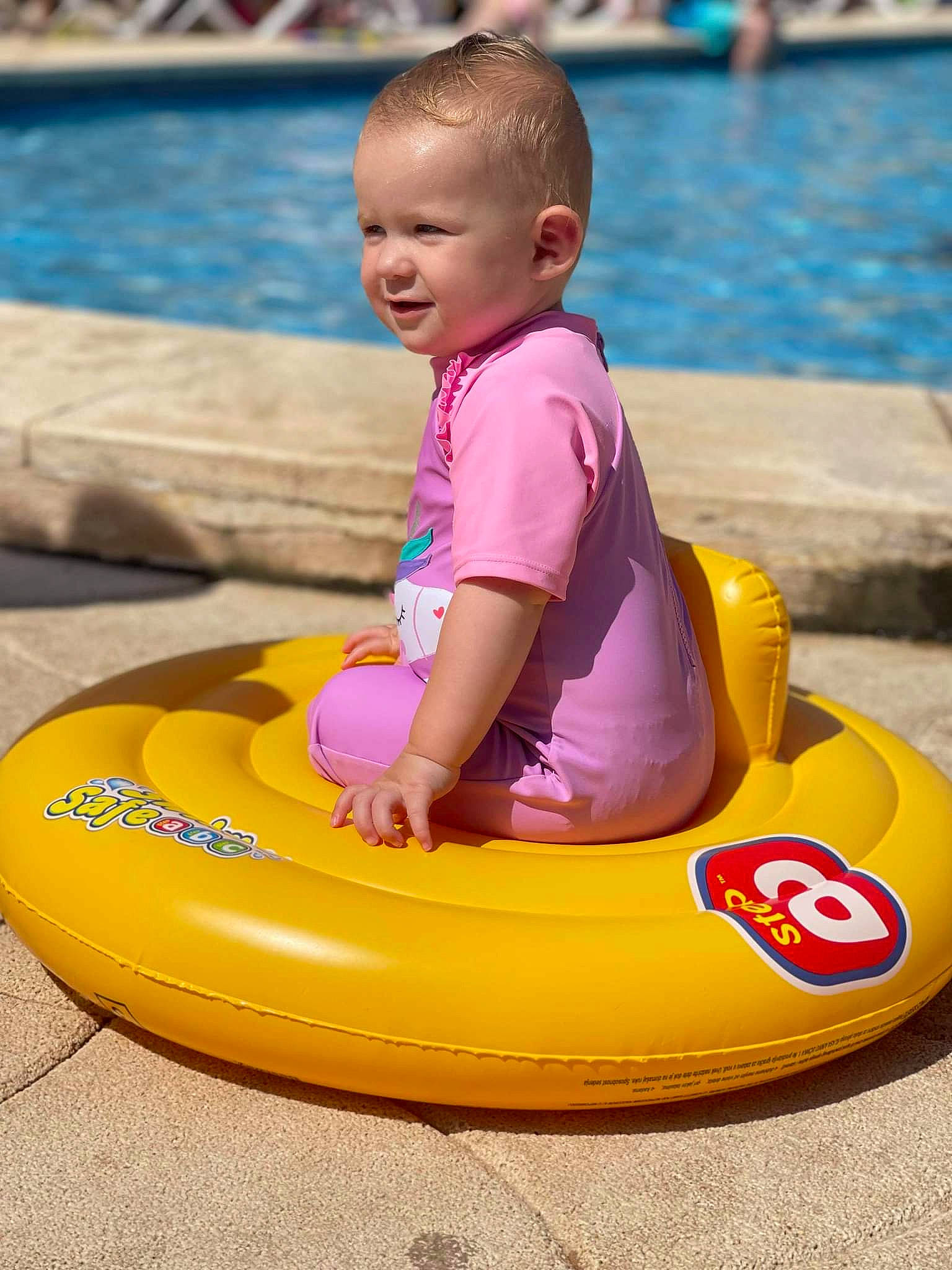 Harper joined the competition — help win amazing prizes! baby, baby_playing_with_toys, baby_toddler_clothing, child, facial_expression, fun, games, happy, leisure, magenta, nonbuilding_structure, person, personal_protective_equipment, play, recreation, riding_toy, sitting, toddler, vacation, water