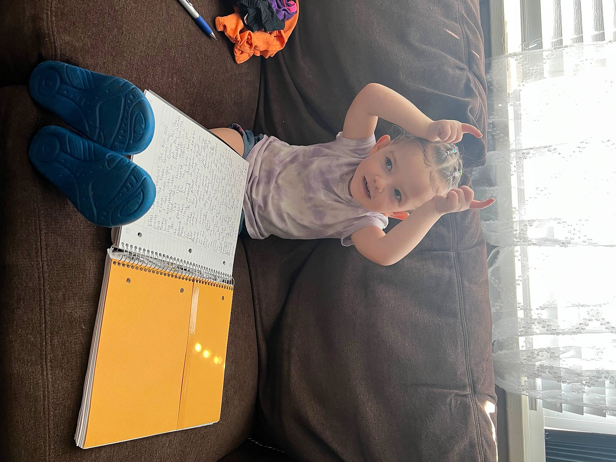 Alayna is registered to the contest to win money with this photo: black, denim, design, electric_blue, entertainment, event, foot, fun, hat, human_leg, joint, knee, leg, person, shipping_box, shoe, sitting, t_shirt, thigh, waist