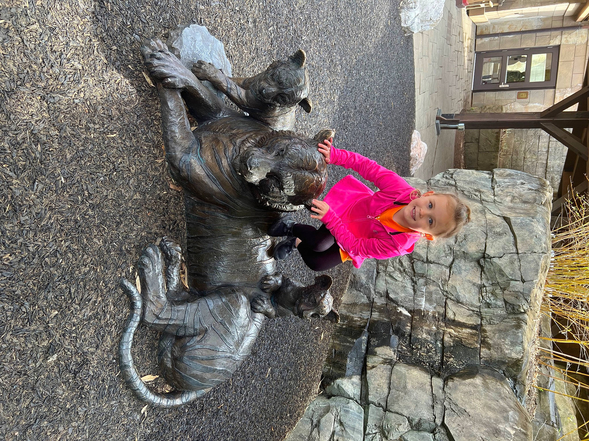 Alayna is registered to the contest to win money with this photo: art, concrete, hat, joy, leisure, person, sculpture, soil, statue, toddler, tree, trunk, working_animal