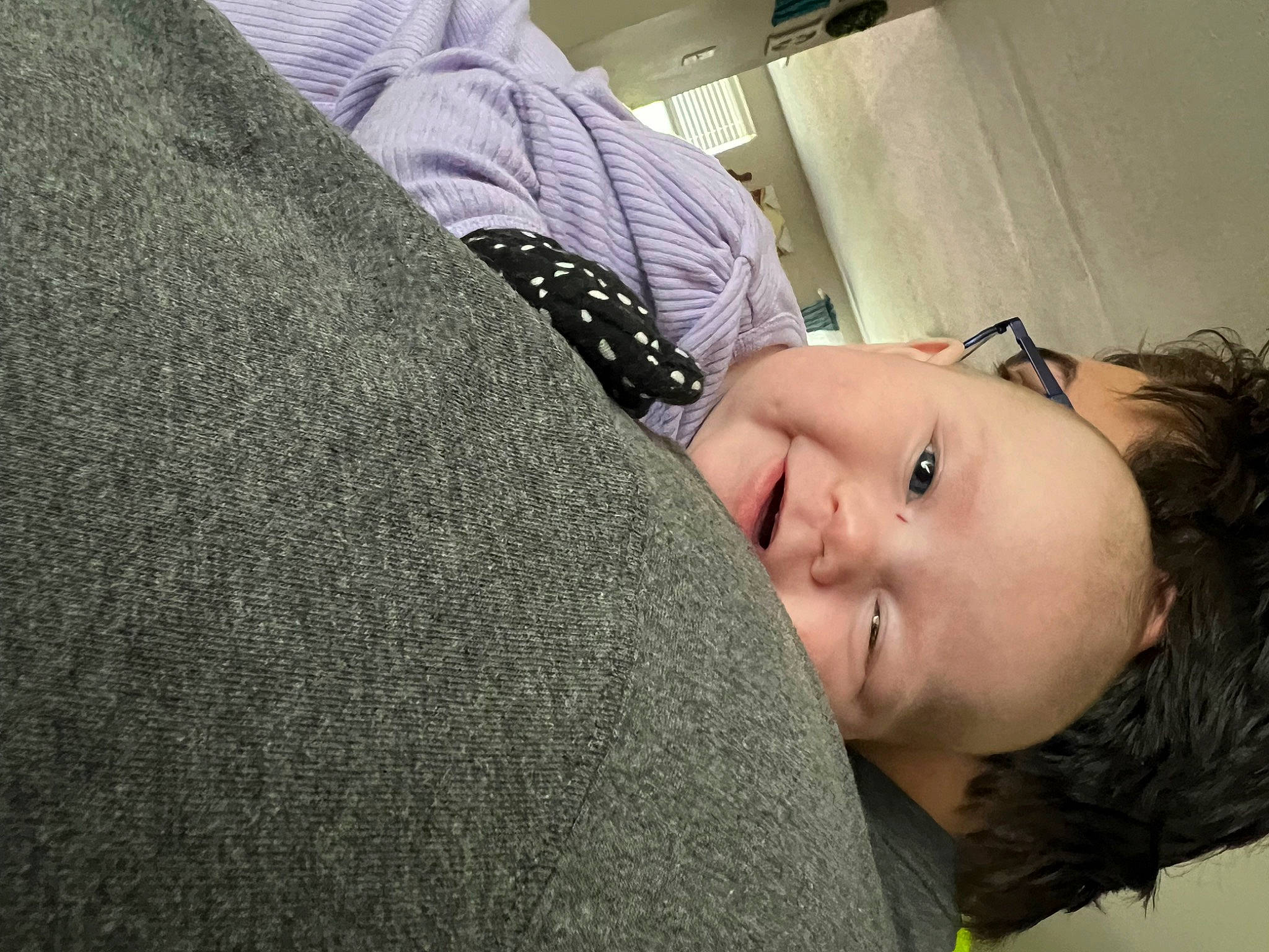 Brooklyn is registered to the contest to win money with this photo: black_hair, child, comfort, ear, elbow, eyelash, flash_photography, gesture, grass, happy, house, hug, lip, long_hair, neck, nose, person, sitting, smile, toddler