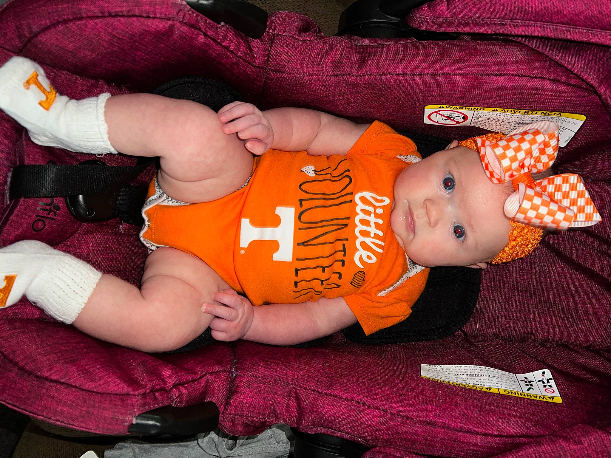 Brooklyn is registered to the contest to win money with this photo: abdomen, baby, baby_products, baby_toddler_clothing, child, comfort, eye, finger, hand, hat, headgear, headwear, human_body, lap, mouth, orange, person, sleeve, thigh, toddler