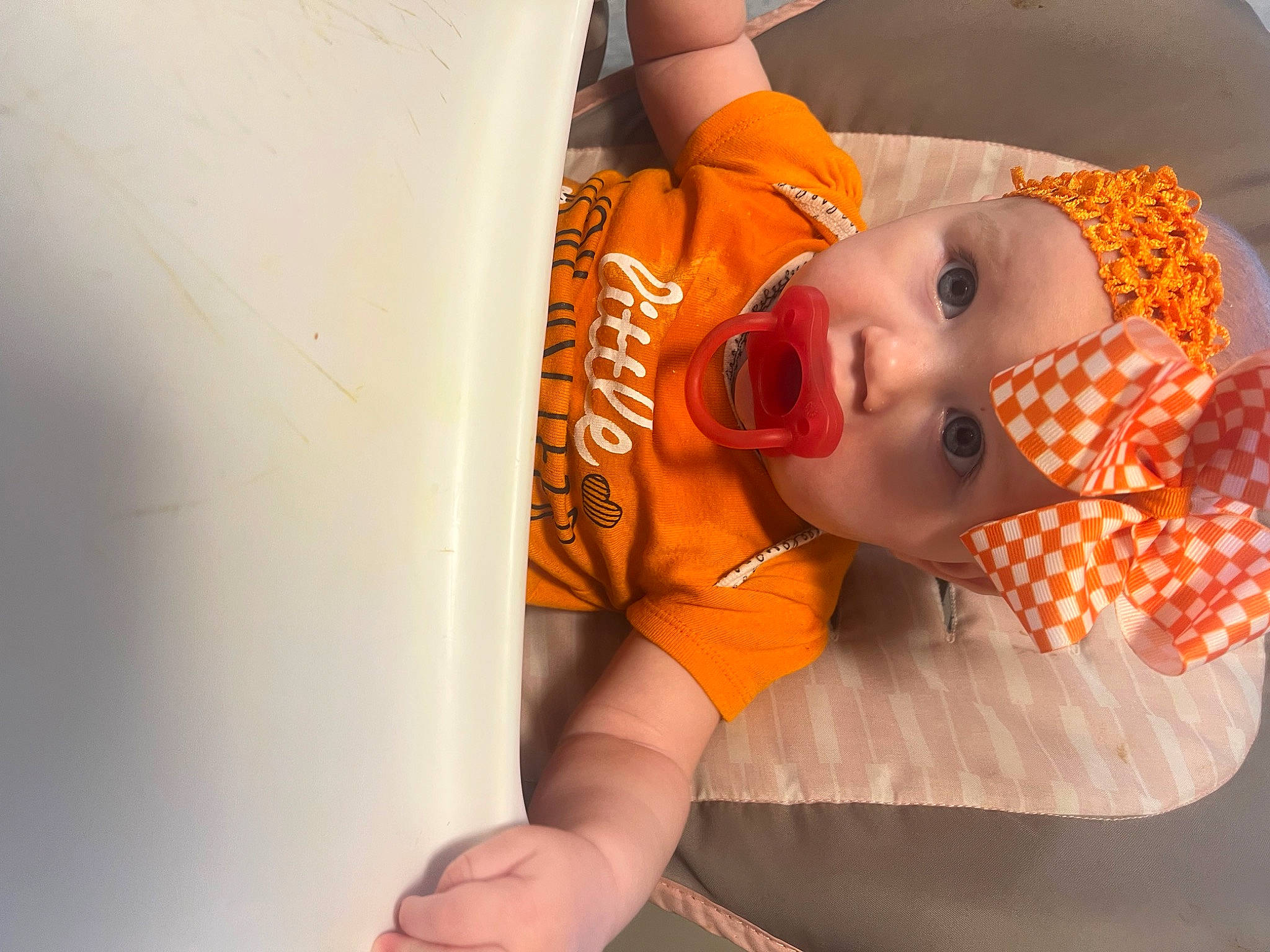 Brooklyn is registered to the contest to win money with this photo: baby, baby_products, baby_toddler_clothing, chest, child, comfort, elbow, eyebrow, eyelash, hat, headwear, orange, pattern, person, room, toddler