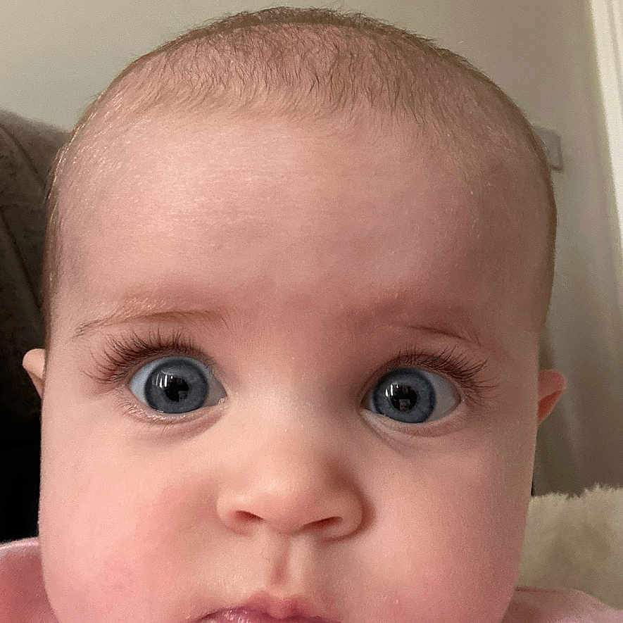 Florence is registered to the contest to win money with this photo: adorable, baby, blue_eyes, child, childhood, close_up, curious_expression, cute, face, head, human, indoors, infant, long_eyelashes, looking_at_camera, pink_clothing, portrait, round_cheeks, soft_skin, young_child