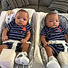 babies, twins, infants, children, matching_outfits, striped_clothing, navy_blue, white, sneakers, baby_seats, bouncers, harnesses, couch, pillows, indoor, portrait, sitting, faces, family, cute