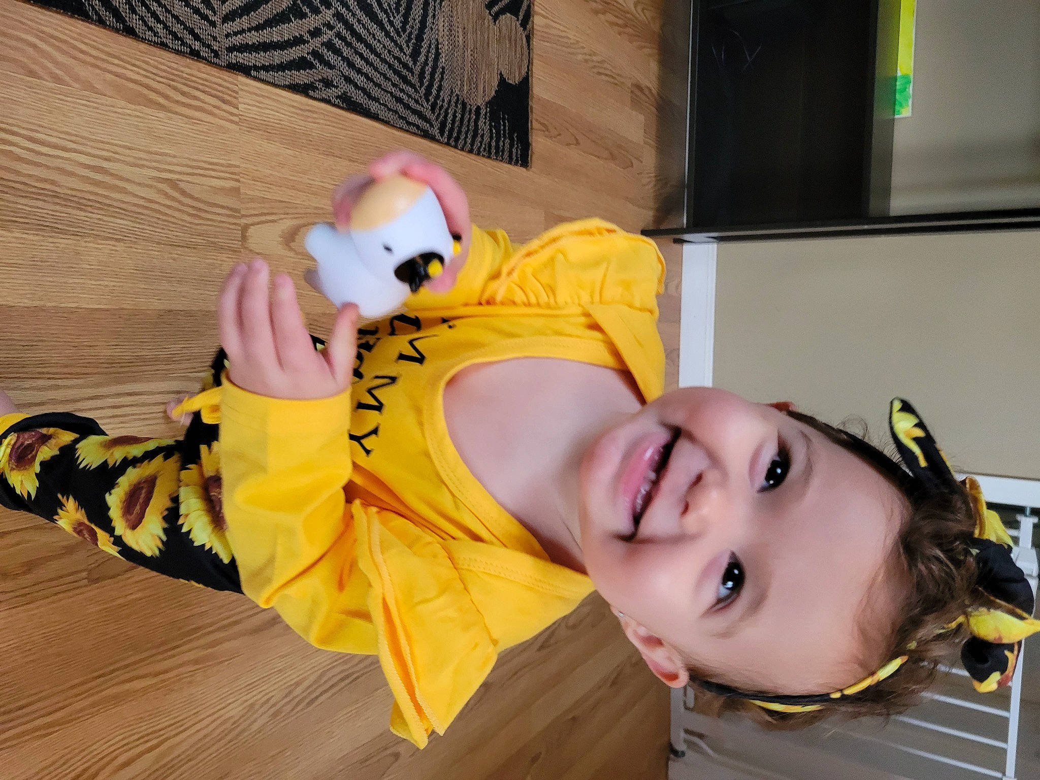 Mackenzie is registered to the contest to win money with this photo: animation, anime, child, costume, eyewear, flooring, fun, happy, headgear, joy, leg, leisure, person, personal_protective_equipment, photo_shoot, sandal, selfie, smile, stuffed_toy, vacation