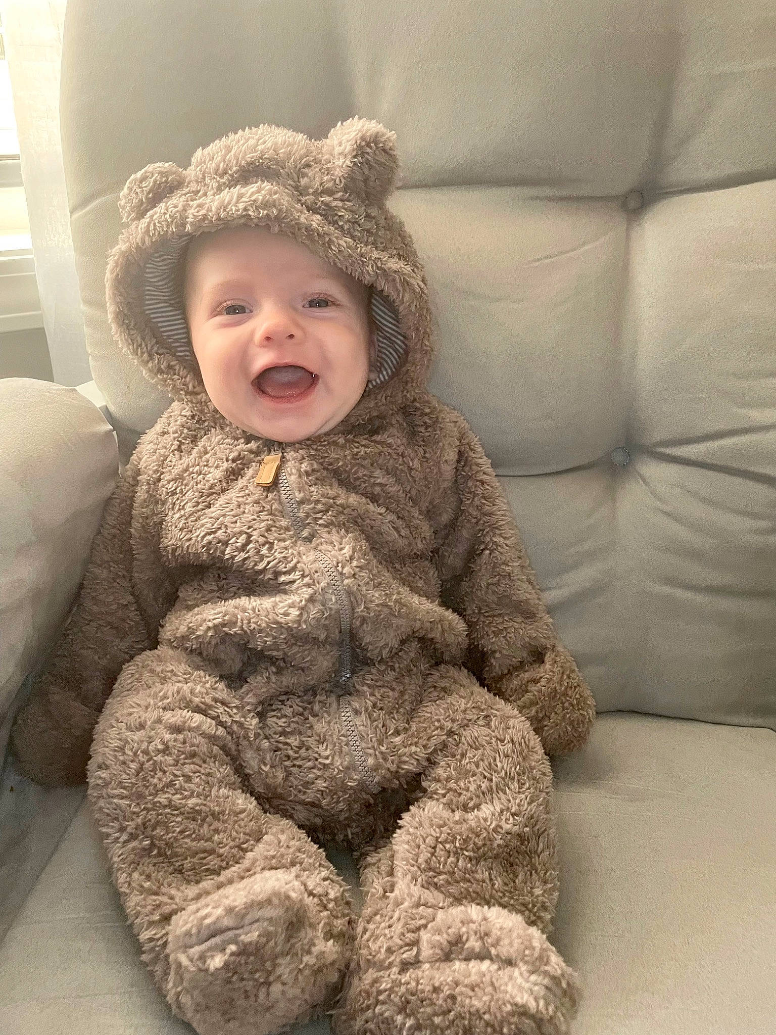 Bentley is registered to the contest to win money with this photo: baby, baby_toddler_clothing, cap, cheek, child, comfort, flooring, fun, fur, happy, headwear, nose, person, portrait_photography, room, sitting, skin, sleeve, smile, teddy_bear