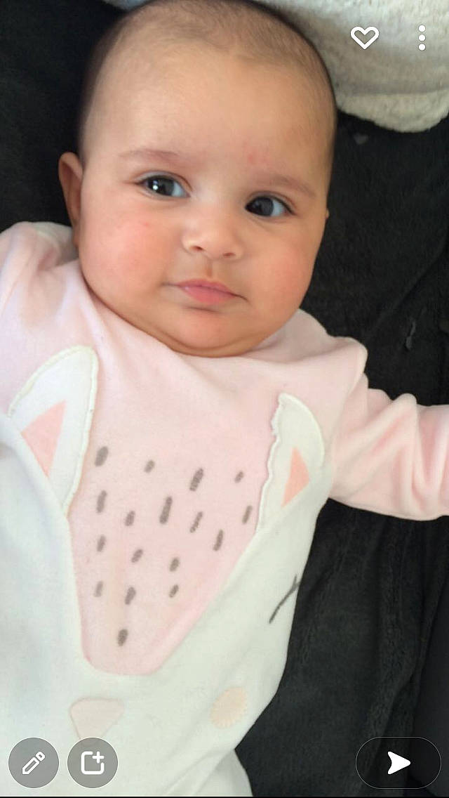 Illyana participe au concours pour gagner de l'argent avec cette photo : arm, baby, baby_toddler_clothing, cheek, collar, comfort, eye, eyebrow, eyelash, gesture, human_body, iris, lip, neck, nose, outerwear, person, pink, sleeve, textile