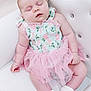 baby, sleeping, crown, tiara, pink_tutu, white_chair, infant, cute, soft_lighting, floral_outfit, newborn, peaceful, adorable, portrait, child, socks, indoor, resting, small_hand, cute_fashion