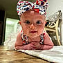 Adelaide joined the competition — help win amazing prizes! baby, infant, child, headband, bow, smiling, face, eyes, hands, floor, blanket, indoors, wooden_floor, furniture, chair, clothing, cute, portrait, toddler, home