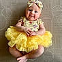 Adelaide joined the competition — help win amazing prizes! baby, child, smiling, yellow_tutu, headband, lying_down, patterned_mat, cute, infant, happy, hands, feet, portrait, indoor, clothing, tulle, person, cute_outfit, playful, adorable