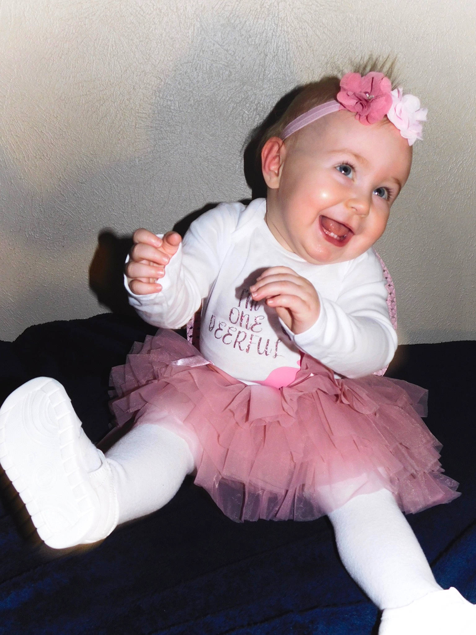 Willow joined the competition — help win amazing prizes! baby, baby_toddler_clothing, child, fashion_accessory, finger, flash_photography, gesture, happy, headband, headpiece, headwear, leg, magenta, person, pink, sitting, skin, sleeve, smile, textile