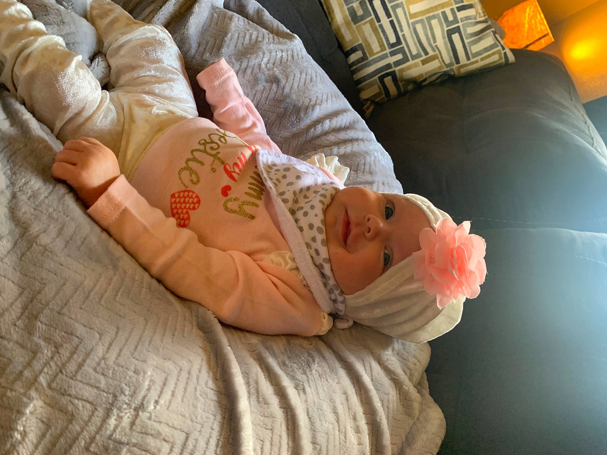 Willow joined the competition — help win amazing prizes! abdomen, arm, baby, bedding, child, comfort, couch, elbow, eye, finger, hand, head, headwear, human_body, human_leg, jewellery, linens, orange, person, sitting