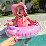 Antonella is registered to the contest to win money with this photo: baby, child, pool, water, inflatable_ring, pink, swimsuit, sunhat, summer, outdoor, happy, smiling, feet, hand, grass, lounge_chair, person, sunlight, vacation, recreation