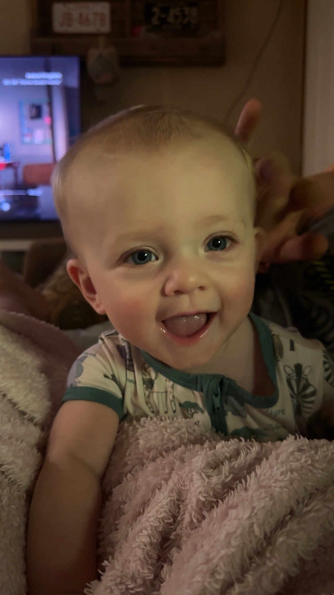 Hudson joined the competition — help win amazing prizes! baby, child, smiling, blanket, indoor, portrait, face, cute, happy, blue_eyes, clothing, person, infant, cozy, soft_texture, expression, young_child, toddler, hand, warmth