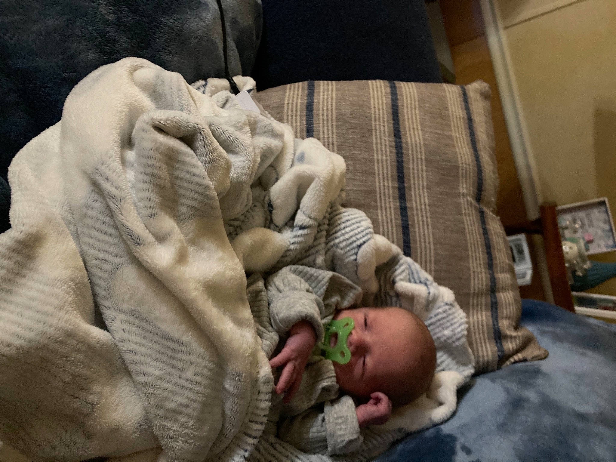 Johnathan is registered to the contest to win money with this photo: baby, baby_toddler_clothing, bedding, child, comfort, couch, eye, finger, gesture, hand, human_body, leg, linens, person, picture_frame, thumb, toddler, vertebrate, wood, wrinkle