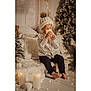 baby, candle, cap, christmas, christmasdecorations, christmastree, clothing, eating, face, festival, food, happy, hat, head, jeans, pants, person, sitting, smile, yawning