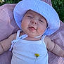 Mia participe au concours pour gagner de l'argent avec cette photo : baby, infant, white_hat, white_tank_top, yellow_flower, pink_blanket, grass, outdoor, smiling, happy, face, headwear, cute, child, nature, summer, sunny, skin, person, portrait