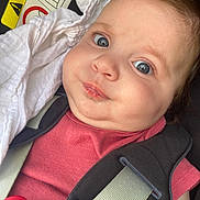 Mia participe au concours pour gagner de l'argent avec cette photo : airbag, baby, blue_eyes, car_seat, child, chubby_cheeks, closeup, cute, face, indoors, infant, pacifier, person, red_shirt, safety, seatbelt, smile, warning_sign, white_cloth, young_child