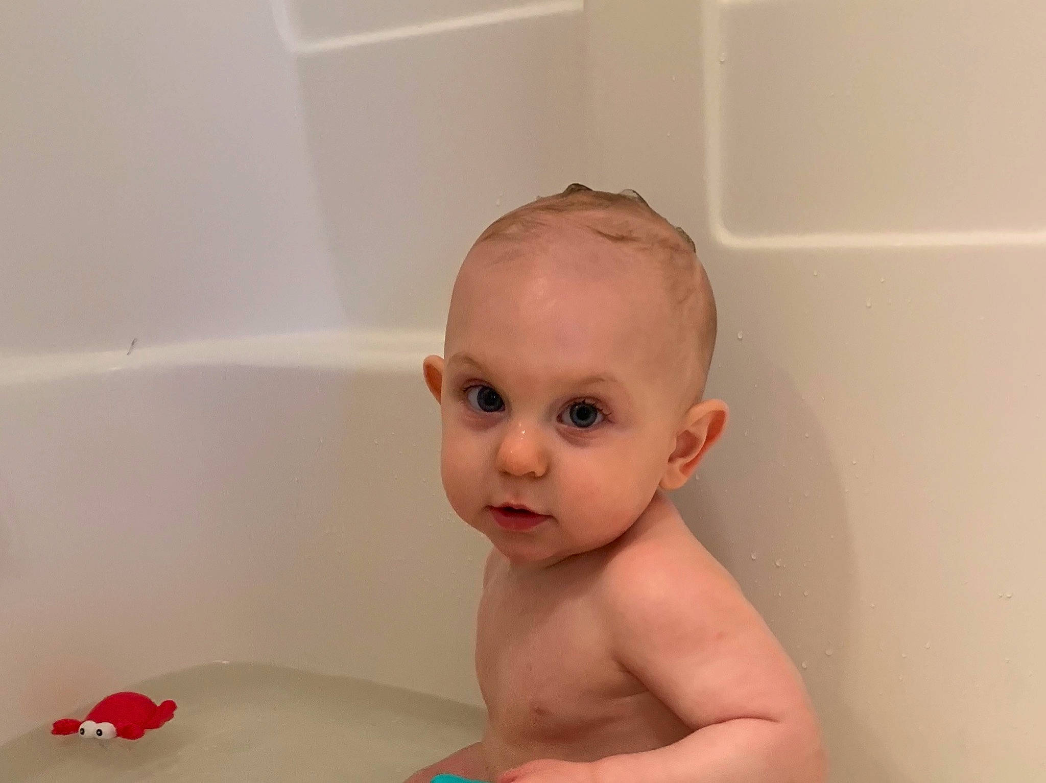 Reid is registered to the contest to win money with this photo: baby, baby_bathing, bathing, bathtub, cheek, child, face, head, joint, nose, person, plumbing_fixture, room, skin, stomach, toddler