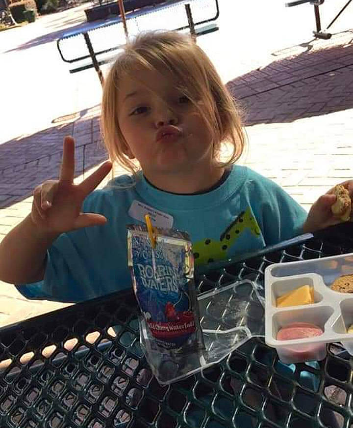 Mckenzie is registered to the contest to win money with this photo: chair, child, drink, fun, gesture, glass, happy, ice_cream, leisure, organ, person, recreation, sitting, smile, t_shirt, tableware, thumb, toddler, travel, vacation