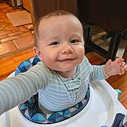 Waylon joined the competition — help win amazing prizes! baby, infant, smiling, baby_walker, pajamas, striped_clothing, indoor, wood_floor, high_chair, child, face, person, cute, happy, home, furniture, kitchen, toy, light, expression