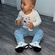 Masha participe au concours pour gagner de l'argent avec cette photo : baby, child, sitting, indoor, floor, wooden_floor, jeans, sneakers, white_shirt, cute, curious, portrait, young_child, casual_clothing, flooring, person, footwear, small_child, toddler, human