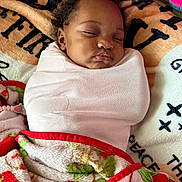 Sareya joined the competition — help win amazing prizes! baby, sleeping, swaddled, blanket, pink_wrap, cozy, face, child, infant, cute, peaceful, resting, soft_texture, patterned_background, floral, colorful, warm_tones, indoors, portrait, young