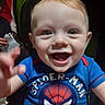 baby, child, smiling, blue_shirt, spiderman, toddler, happy, face, hand, portrait, cute, indoor, person, clothing, shorts, red, blond_hair, eyes, mouth, expression