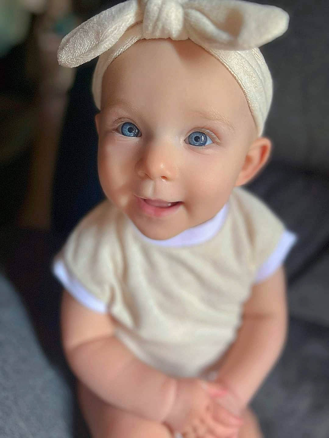 Kahlia is registered to the contest to win money with this photo: baby, baby_toddler_clothing, cap, cheek, chin, costume_hat, dress, ear, eye, face, flash_photography, happy, head, headgear, iris, lip, person, skin, sleeve, smile