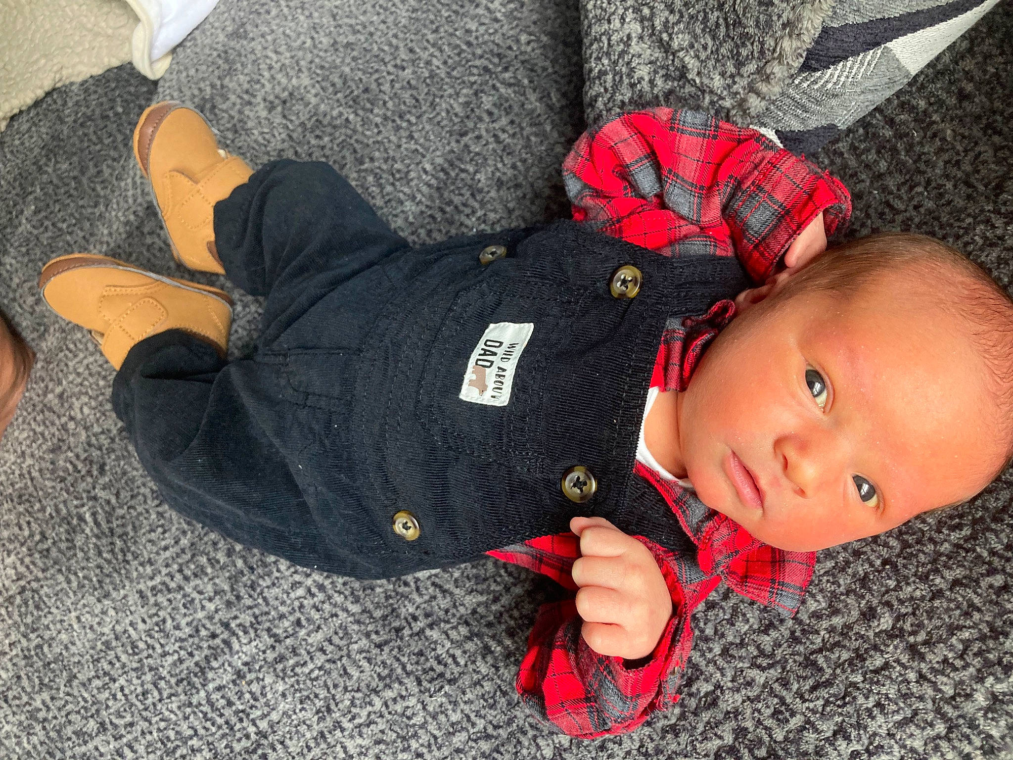 Cayden joined the competition — help win amazing prizes! baby, baby_products, baby_toddler_clothing, beanie, carmine, child, comfort, flooring, gesture, hand, lap, nail, pattern, person, sitting, sleeve, thumb, toddler, tree, wood