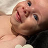 Kolsen joined the competition — help win amazing prizes! baby, smiling, tongue_out, face, blue_eyes, infant, close_up, pacifier, skin, cheeks, cute, lying_down, happy, baby_toy, indoor, person, child, newborn, expression, soft_lighting