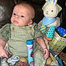 Kolsen joined the competition — help win amazing prizes! baby, child, basket, plush_toy, rabbit, candy, eggs, green_clothing, overalls, leather_couch, indoor, toy, pacifier, sitting, looking_away, soft_toy, colorful, cute, infant, portrait