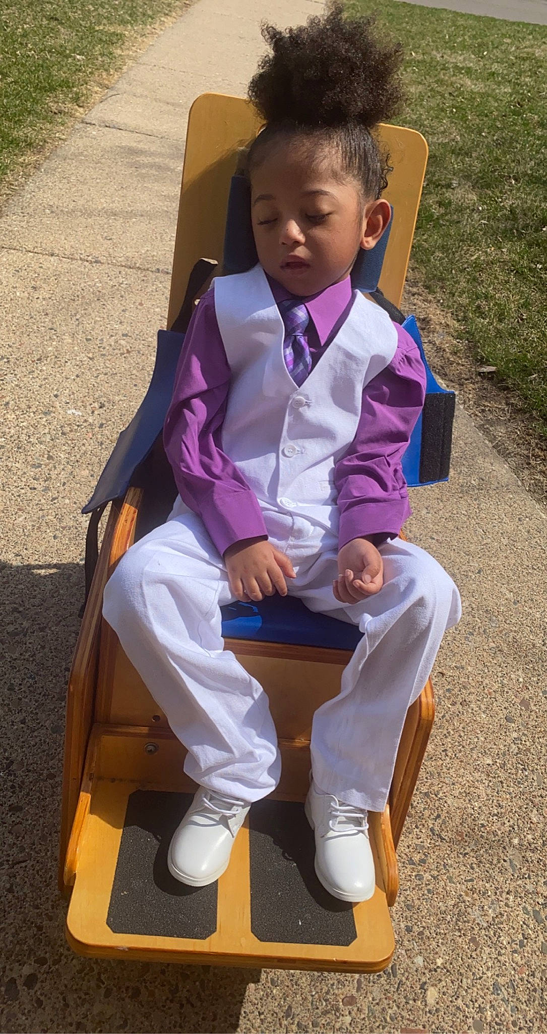 Terrell is registered to the contest to win money with this photo: eye, face, grass, hair, happy, head, human_leg, knee, lap, leisure, person, photograph, plant, purple, recreation, shoe, sleeve, sneakers, sock, thigh