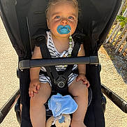 Sandro participe au concours pour gagner de l'argent avec cette photo : baby, stroller, pacifier, blue_eyes, plush_toy, sunlight, outdoor, child, infant, seatbelt, toy, striped_clothing, barefoot, beads, sitting, comfort, portrait, daylight, nature, relaxation