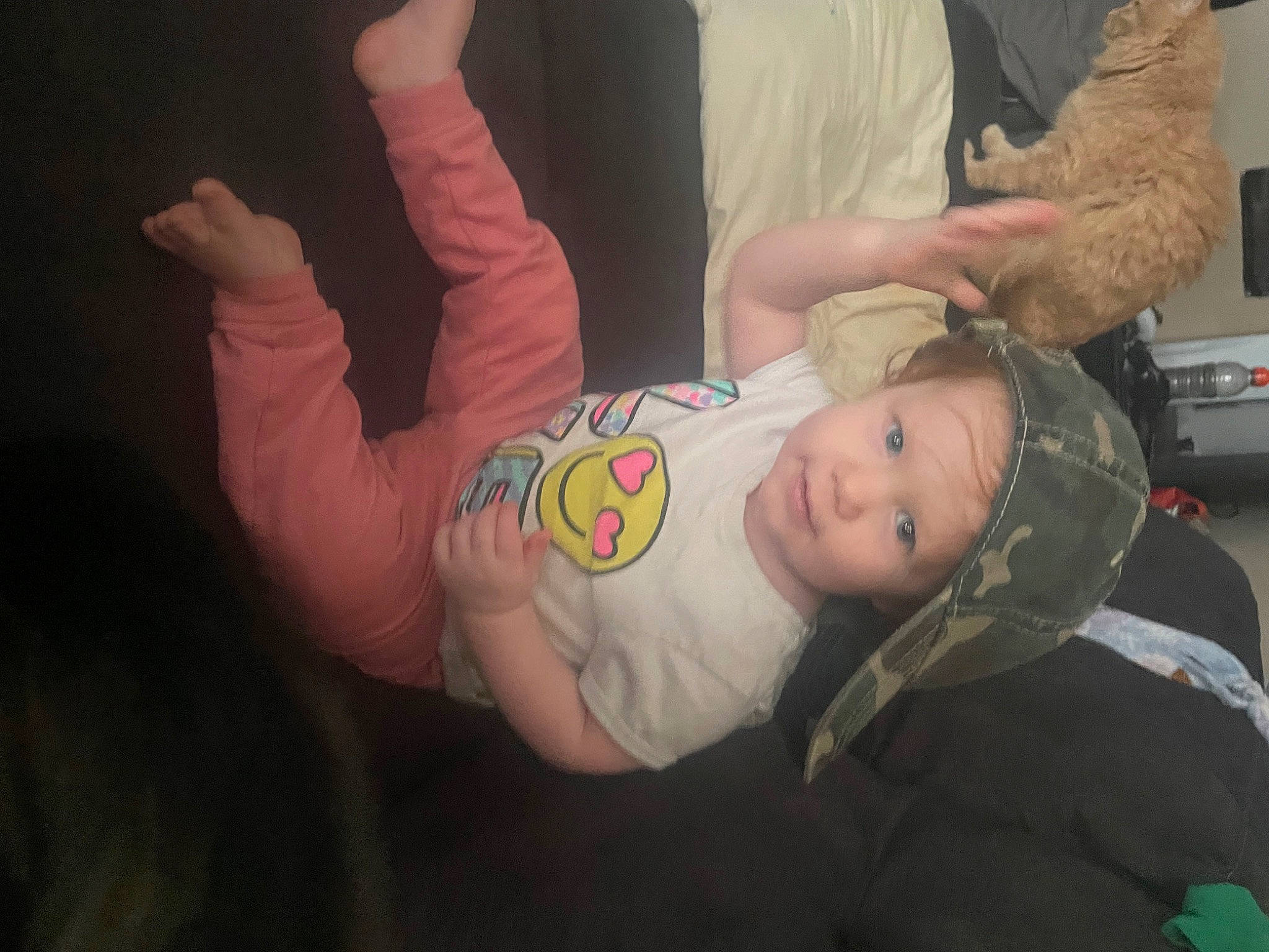 Chloe is registered to the contest to win money with this photo: abdomen, baby, baby_products, baby_toddler_clothing, child, comfort, event, eye, finger, fun, gesture, happy, headwear, leg, person, room, sitting, sleeve, smile, t_shirt