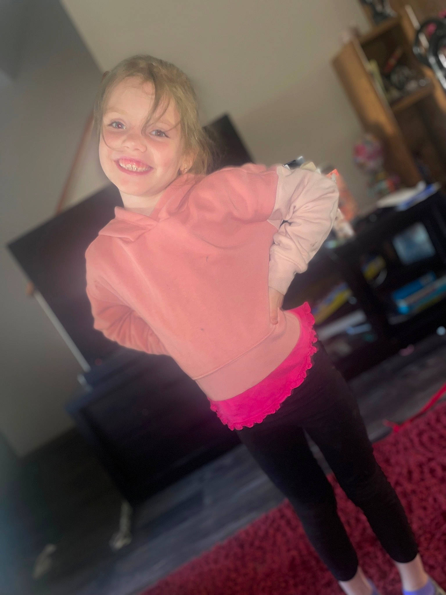 Ava is registered to the contest to win money with this photo: brown_hair, eye, face, flooring, fun, head, human_leg, joint, joy, knee, long_hair, magenta, person, pink, shoulder, sitting, smile, sock, sportswear, standing