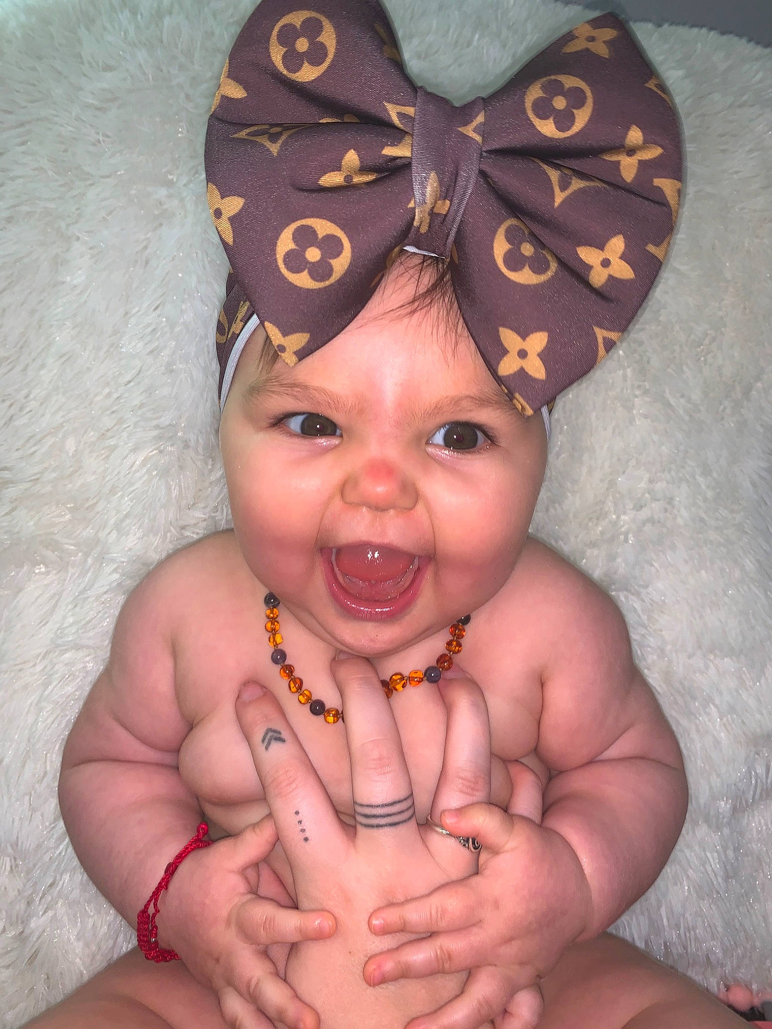 Ensley is registered to the contest to win money with this photo: baby, cheek, chest, child, costume_accessory, ear, face, finger, hair_accessory, hand, head, headgear, headpiece, headwear, mouth, muscle, neck, person, skin, smile