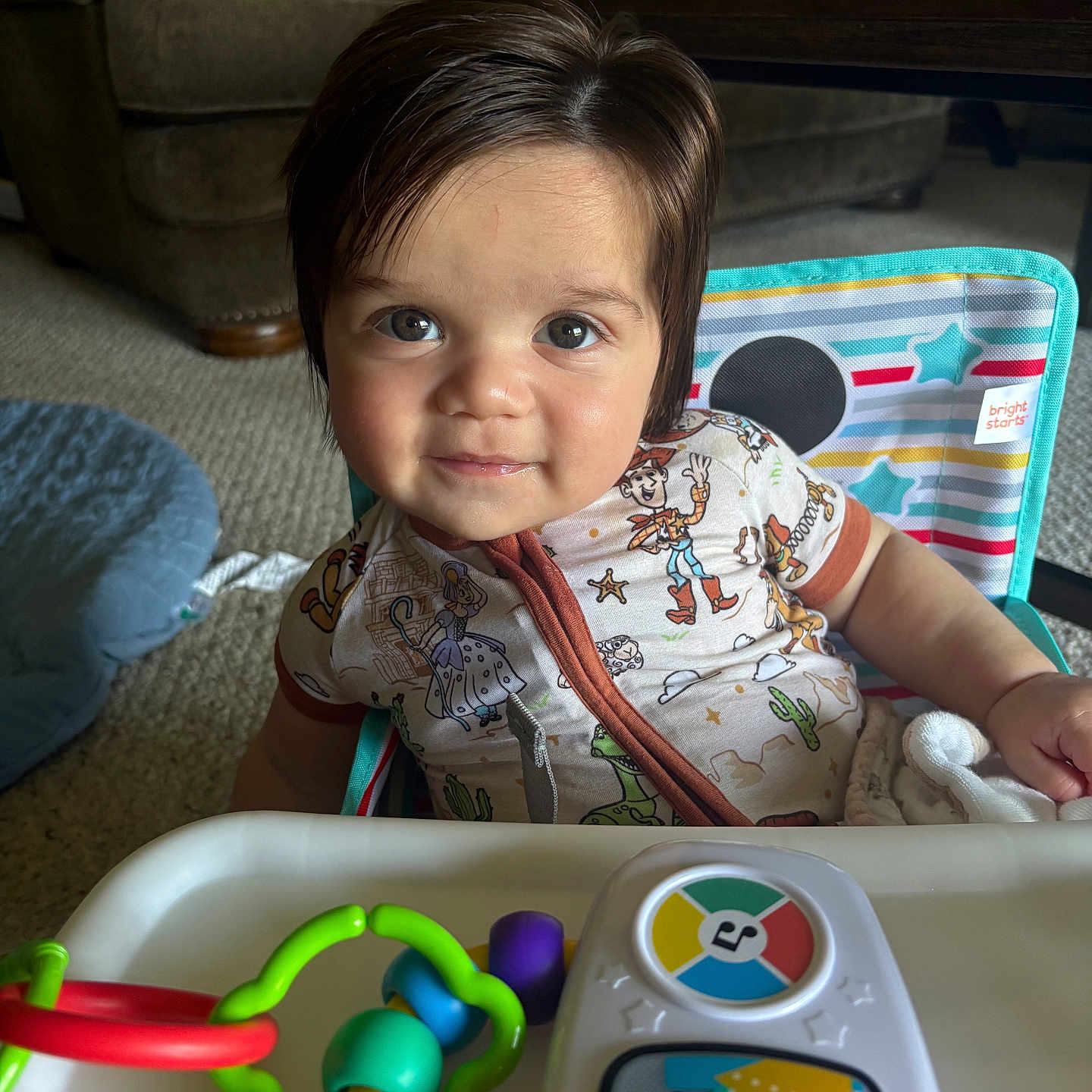 Santino joined the competition — help win amazing prizes! toddler, child, face, smile, toy_story, high_chair, toy, colorful, indoor, carpet, couch, pillow, clothing, person, play, happy, hair, eyes, furniture, living_room