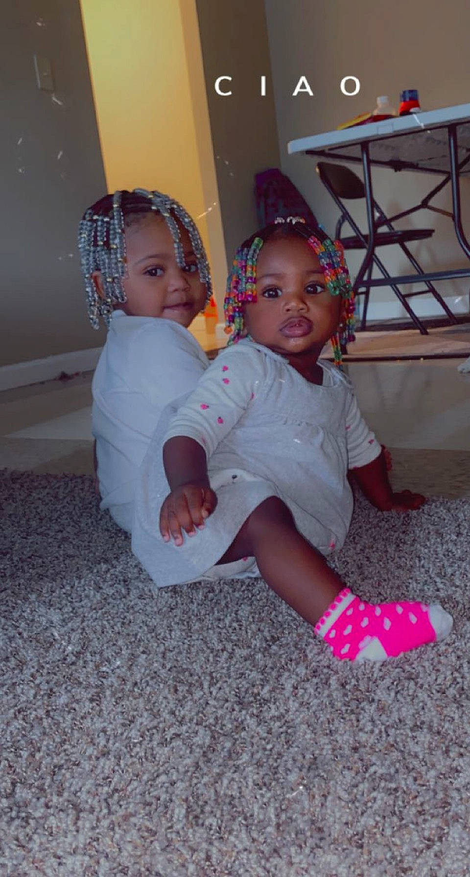 Laylah is registered to the contest to win money with this photo: baby, baby_toddler_clothing, child, event, facial_expression, floor, flooring, foot, fun, happy, headband, human_leg, knee, lap, magenta, person, sitting, skin, sock, thigh