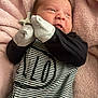 Liam joined the competition — help win amazing prizes! baby, newborn, infant, pink_blanket, soft_blanket, mittens, striped_outfit, onesie, remote_control, portrait, close_up, face, head, hands, cozy, sleepy, indoor, human, expression, black_sleeves