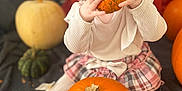 River-Lavinia is registered to the contest to win money with this photo: baby, child, pumpkin, orange, plaid_skirt, white_tights, bow, fall, autumn, cute, indoor, sitting, food, playful, holiday, seasonal, festive, harvest, decor, cozy