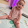 baby, child, infant, sitting, play_mat, indoors, smiling, cute, person, floor, pink_clothing, happy, young_child, skin, head, legs, hand, room, background, toy