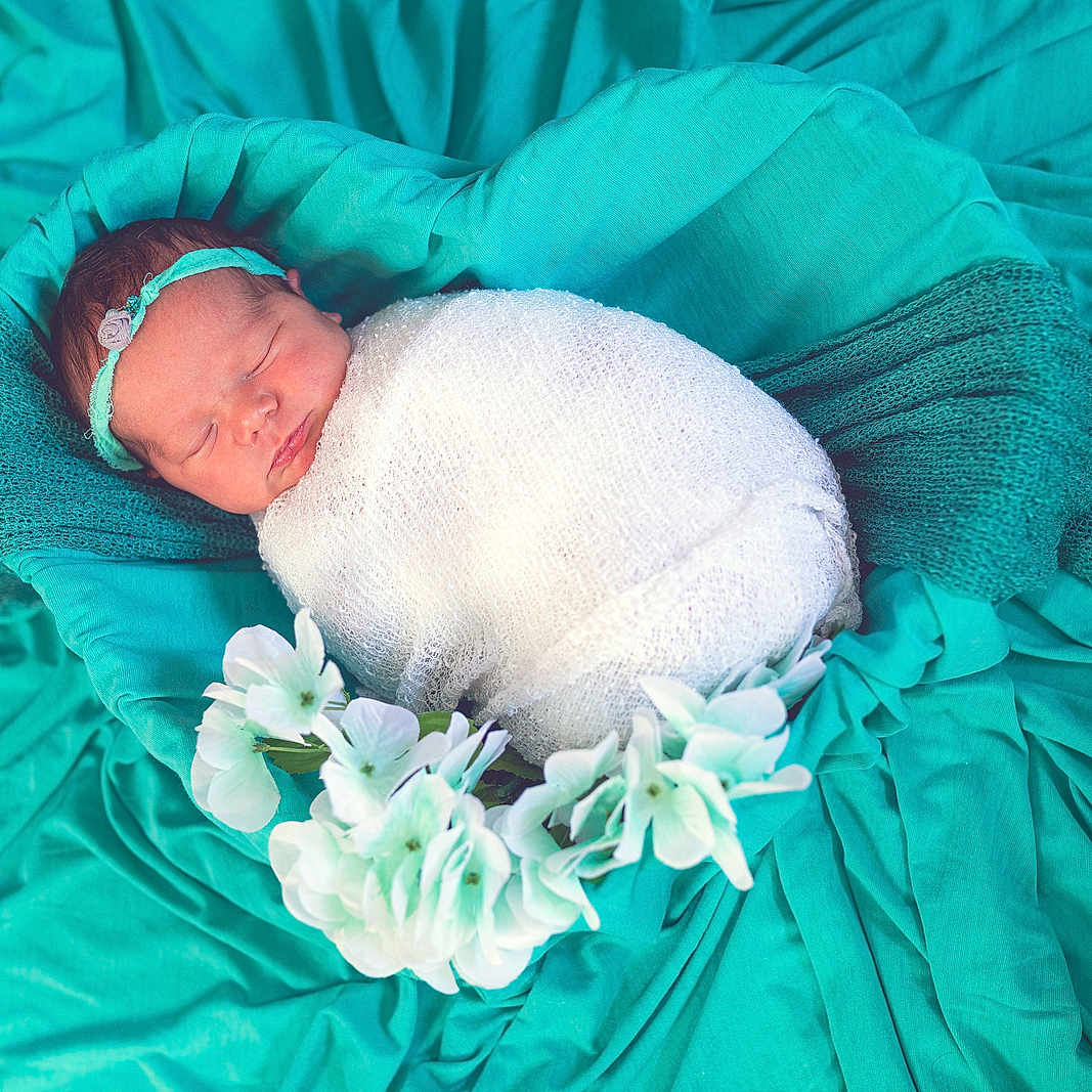 Hazleigh is registered to the contest to win money with this photo: baby, bed, blanket, bonnet, clothing, cushion, face, flower, flowerarrangement, flowerbouquet, furniture, head, homedecor, newborn, person, petal, photography, plant, portrait, sleeping
