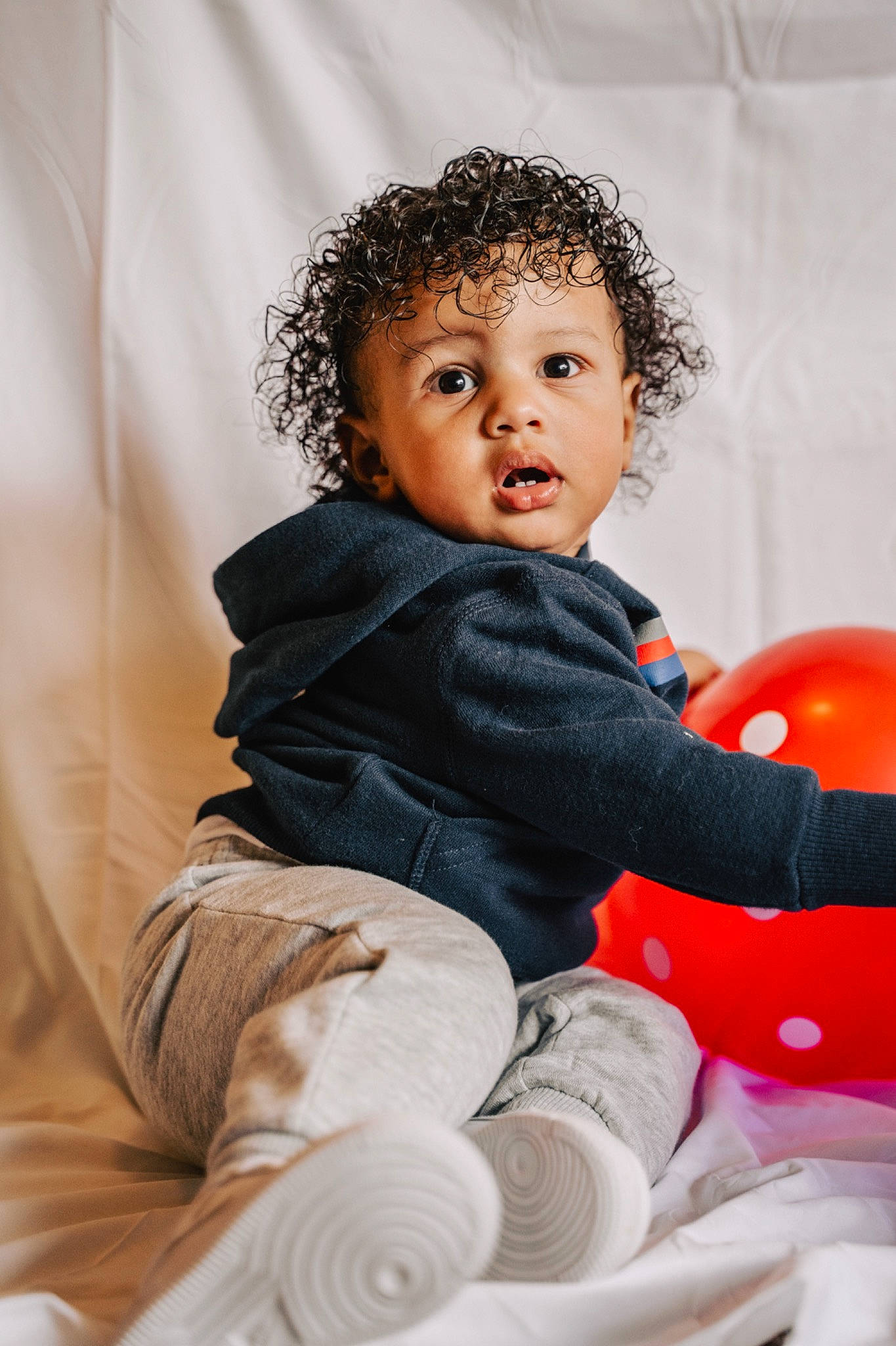 Amir joined the competition — help win amazing prizes! arm, baby, cheek, child, child_model, eye, fun, human, person, photography, play, red, room, sitting, skin, toddler, white